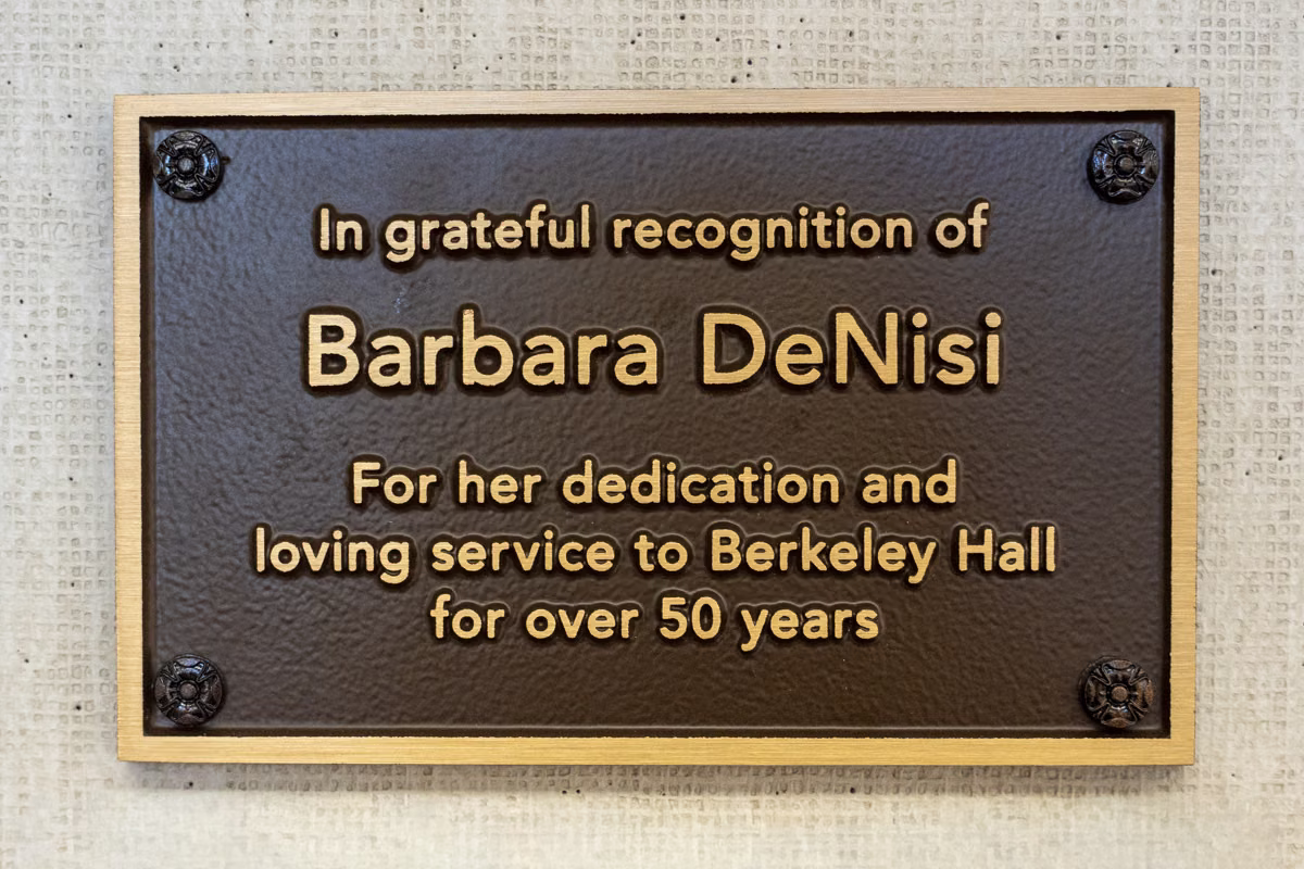 Plaque honoring Barbara DeNisi for her dedication and loving service to Berkeley Hall for over 50 years.