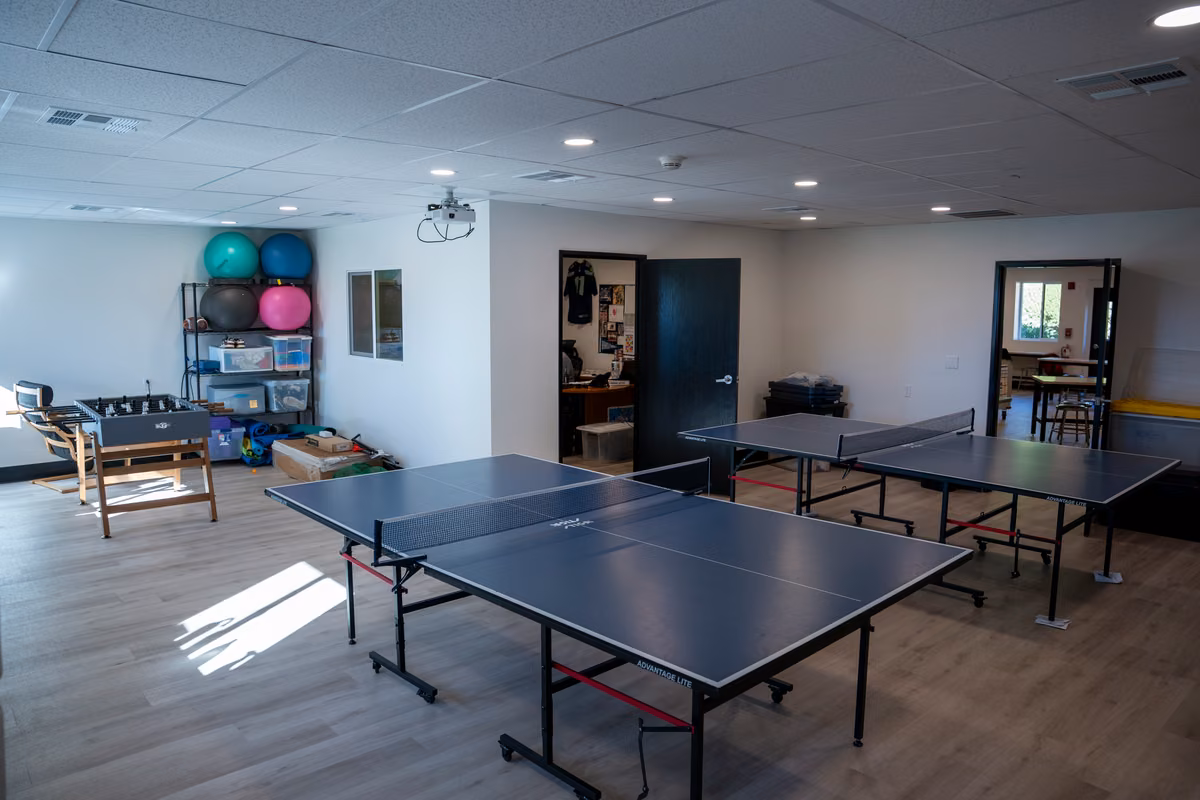 Table-tennis tables and gathering space inside the updated Dojo.