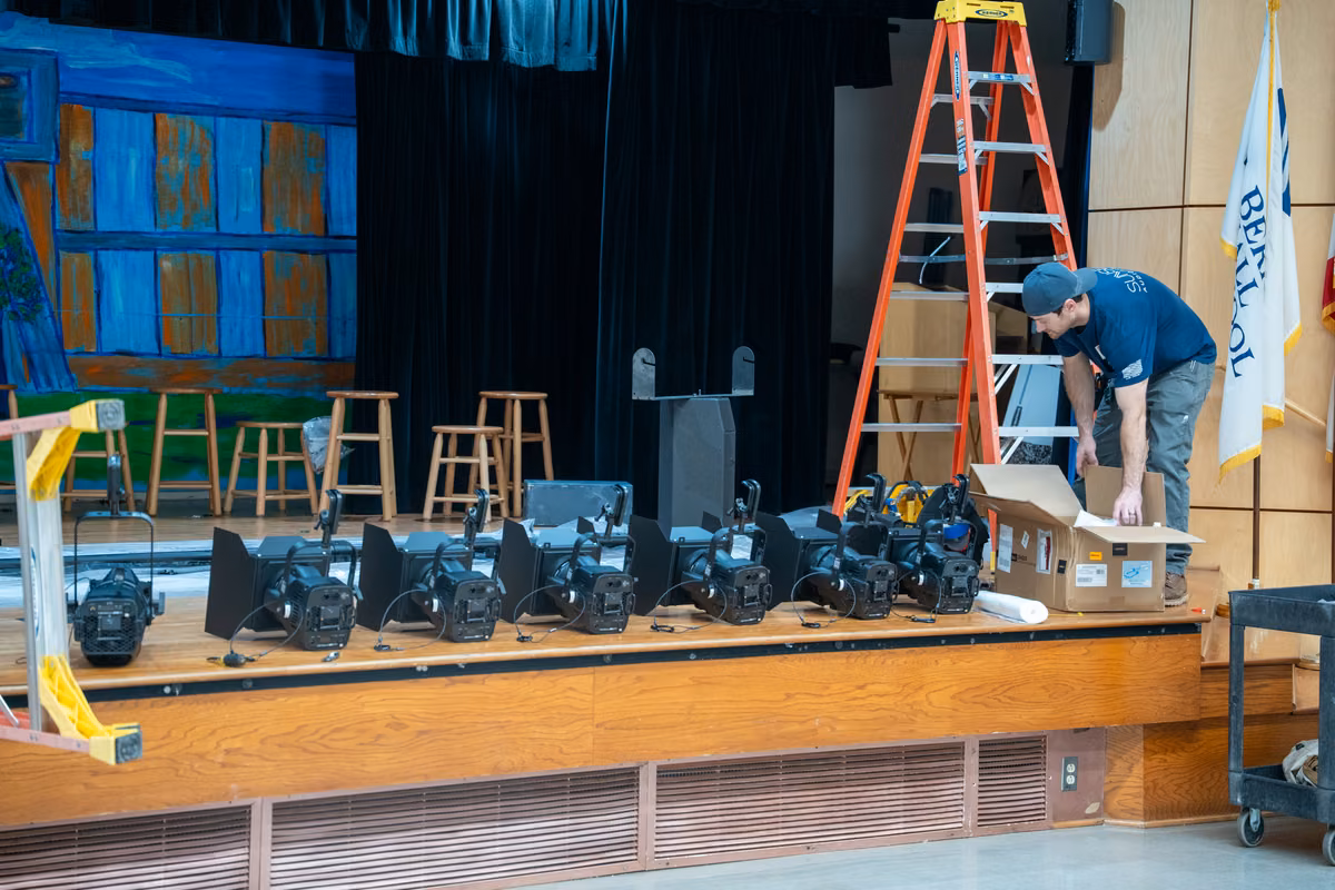 A technician prepares stage-lighting equipment on the Hodges stage.