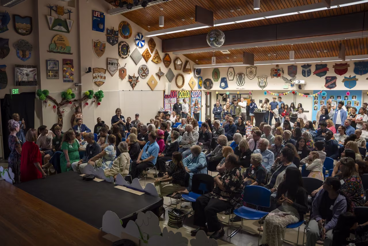 A wide view of seated guests and speakers during the DeNisi Legacy Celebration.