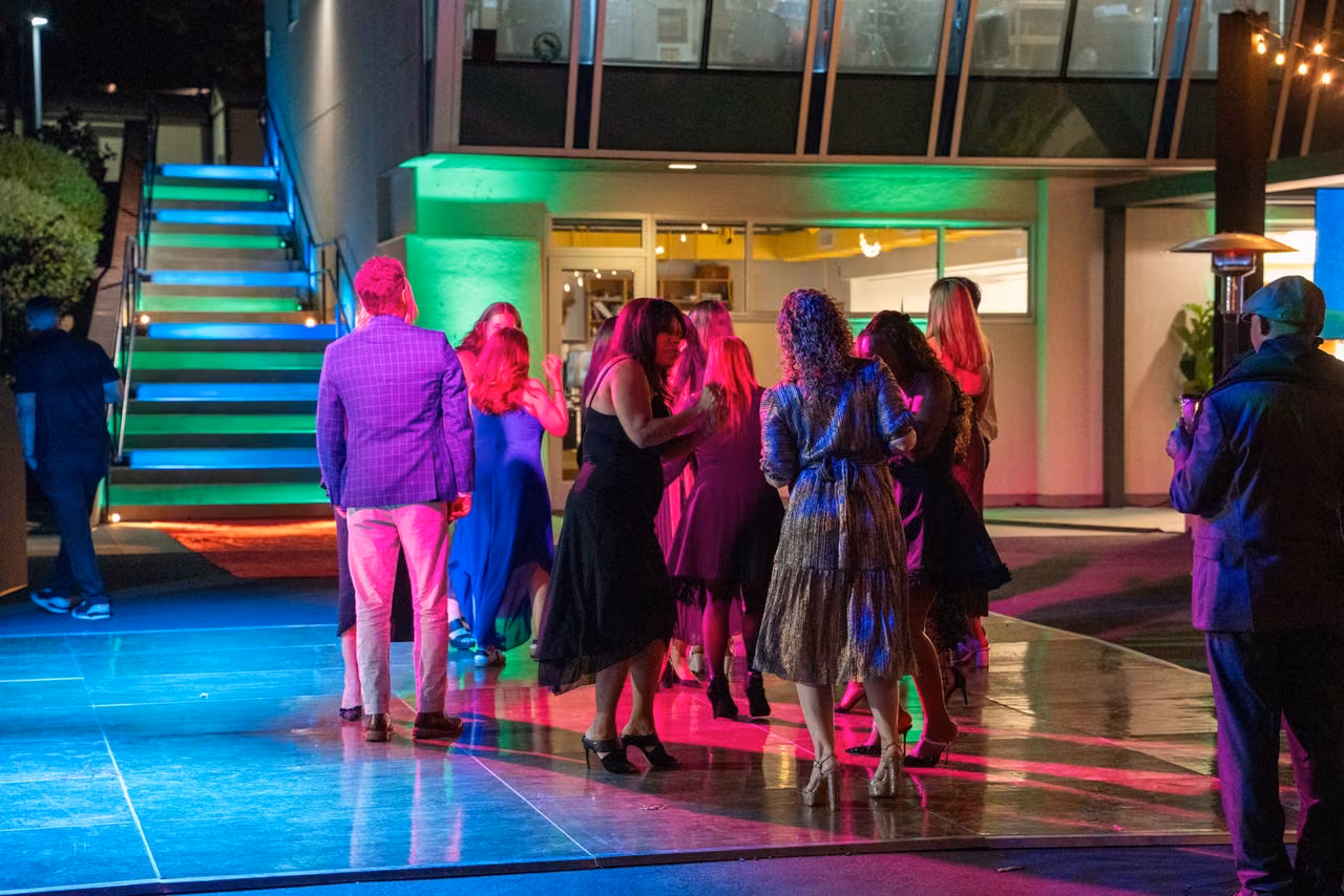 Guests gather on the illuminated dance floor outside the Innovation Lab.
