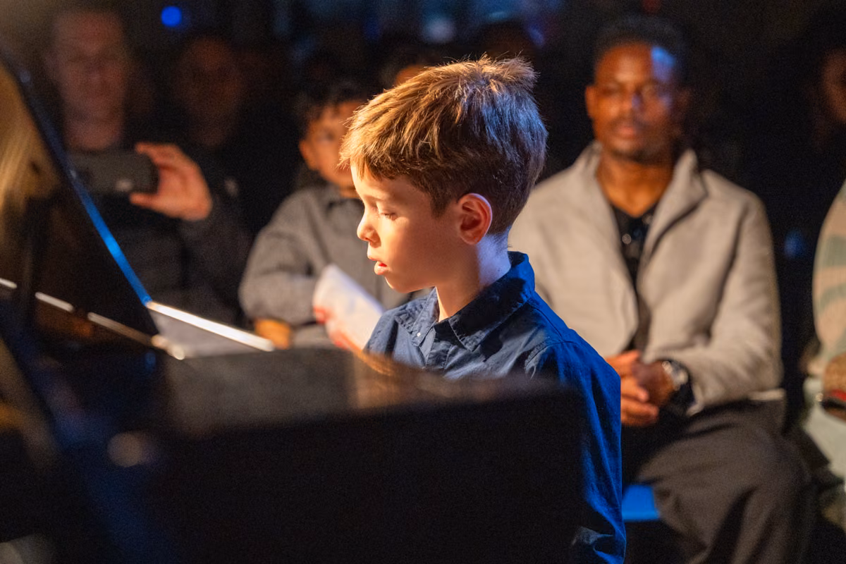 A student concentrates at the piano during the Variety Show.